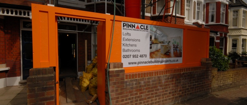 The custom orange hoarding with banner