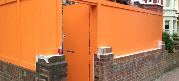 The traditional orange hoarding on the front of the property