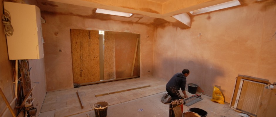 The floor tiles being laid - plastering has been done