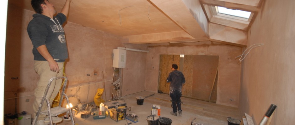 Plaster is drying, floor tiles being laid and wiring being done
