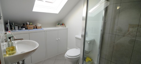 Loft shower room with cupboards