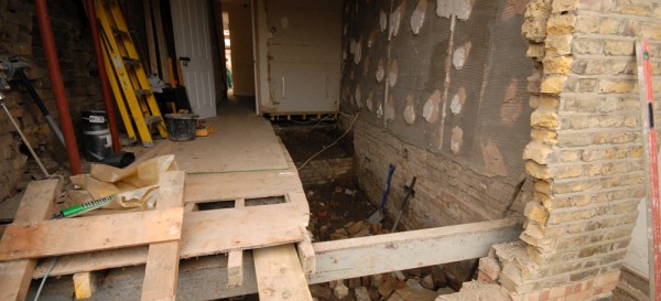 Lowering the floor level - note temporary beam in place which will help support the house while box frame is inserted