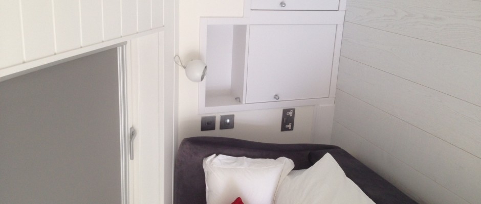 Built-in bedside tables and cupboards, light switches and electric sockets in the Barnes loft conversion