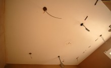 Positioning the holes for the bathroom rated down lights in the ceiling