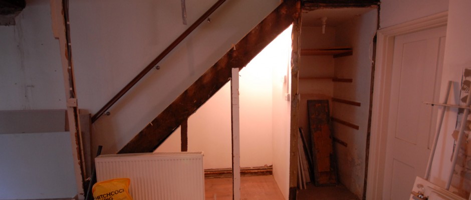 The stairs leading down into this semi basement have been opened up - we will build bespoke cupboards underneath the stairs for storage for this house in Shepherds Bush