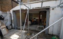 The wall has been knocked through and the box frame is now in place. The bottom steel has been encased in cement.