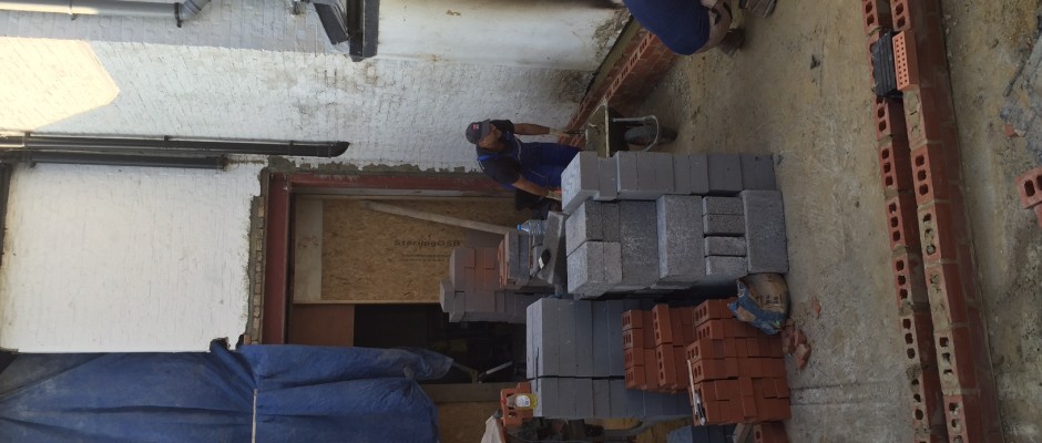 Laying the DPM and first layers of brick on to the concrete slab